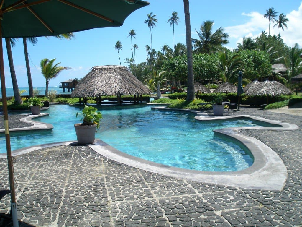 Tropical paradise pool with stunning ocean views for Coconuts Beach Club resort in the Pacific Islands